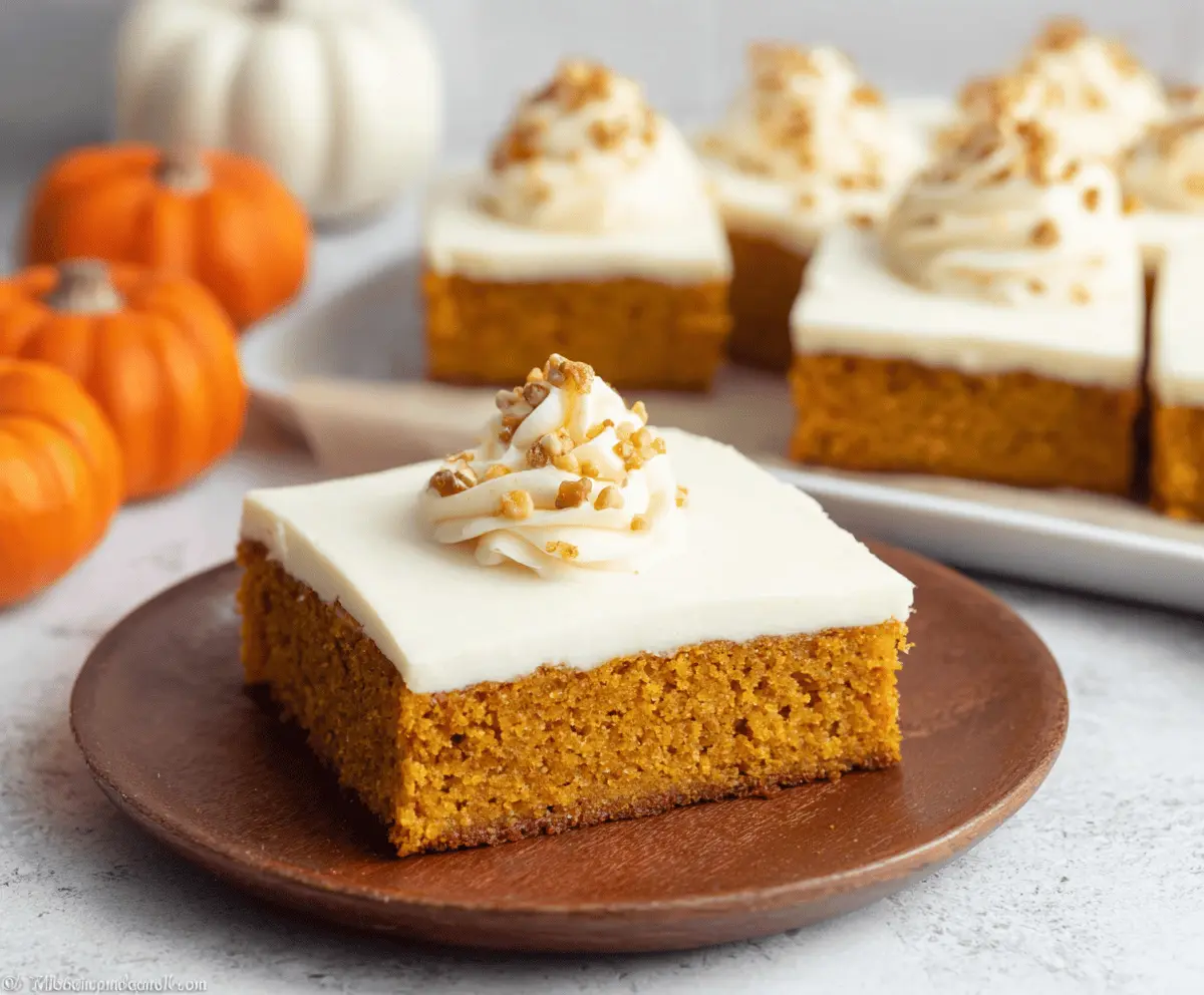 Delicious pumpkin sheet cake topped with creamy cream cheese frosting, perfect for fall desserts