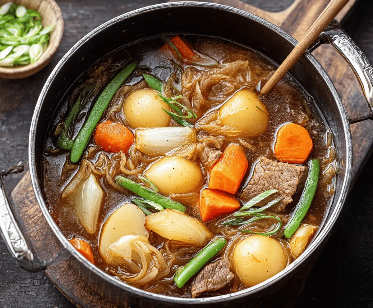 Delicious One Pot Japanese Nikujaga with tender beef, potatoes, carrots, and onions served in a savory broth