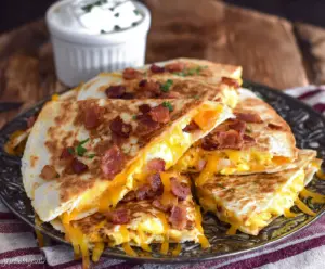 Delicious bacon, egg, and cheese breakfast quesadillas served on a plate.