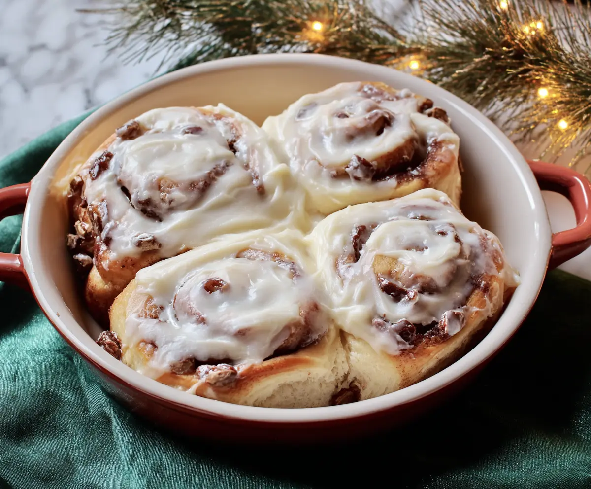 Delicious cinnamon rolls topped with creamy cream cheese frosting, perfect for breakfast or dessert.