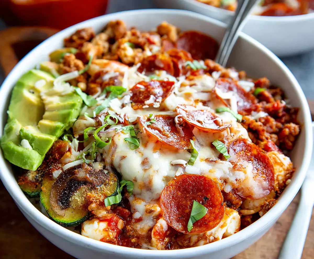 Delicious Pizza Protein Bowl topped with fresh vegetables and melted cheese