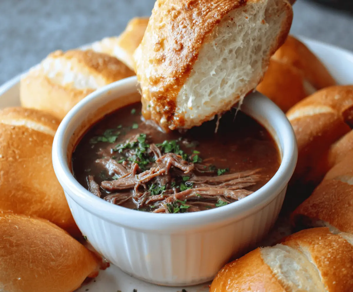 Delicious 5-ingredient beef dip in a bowl with bread on a rustic table