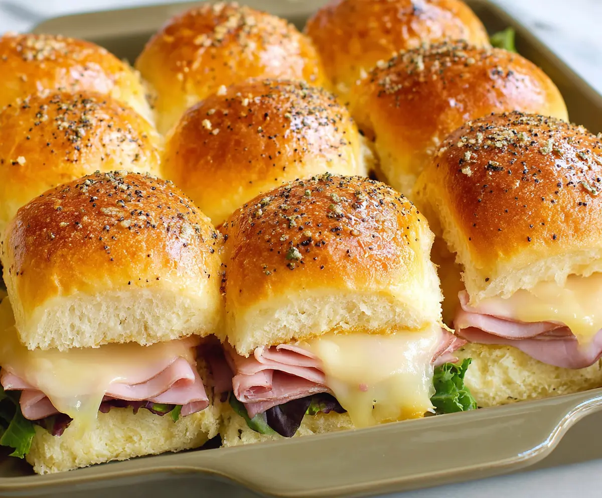Delicious Ham and Cheese Hawaiian Roll Sliders with melted cheese and fresh ham slices.