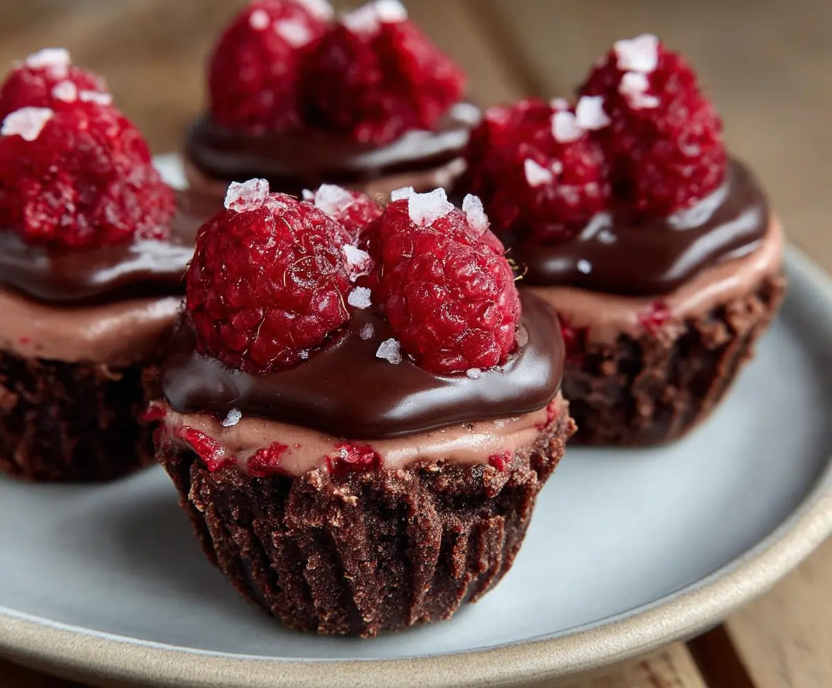 Delicious Raspberry Chocolate Mousse Cups topped with fresh raspberries and chocolate shavings.