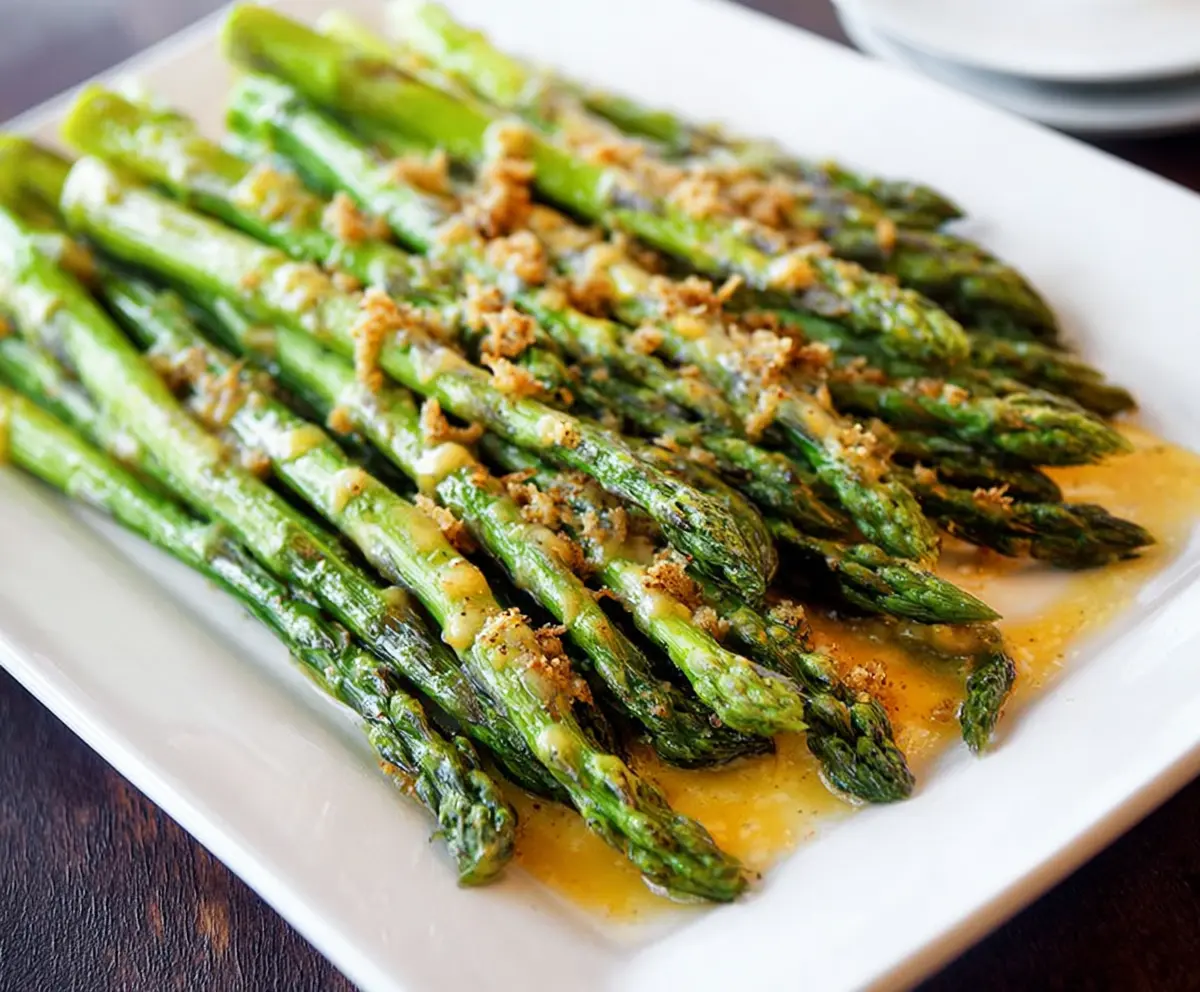 Delicious honey mustard glazed asparagus served on a white plate, perfect for a healthy side dish.