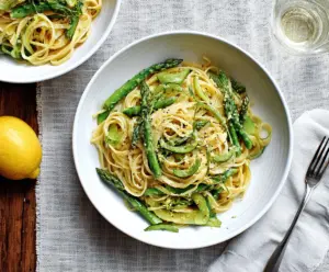 Delicious Lemon Asparagus Pasta dish with fresh asparagus and zesty lemon sauce on a white plate