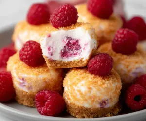 Delicious Raspberry Cheesecake Bites with fresh raspberries on top. Perfect for parties and desserts.